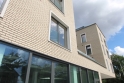 Zateplená fasáda moderní Vitality Rezidence je z cihlových pásků